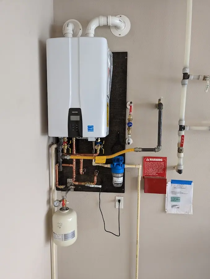 Professional plumber installing copper piping in a East Buffalo home